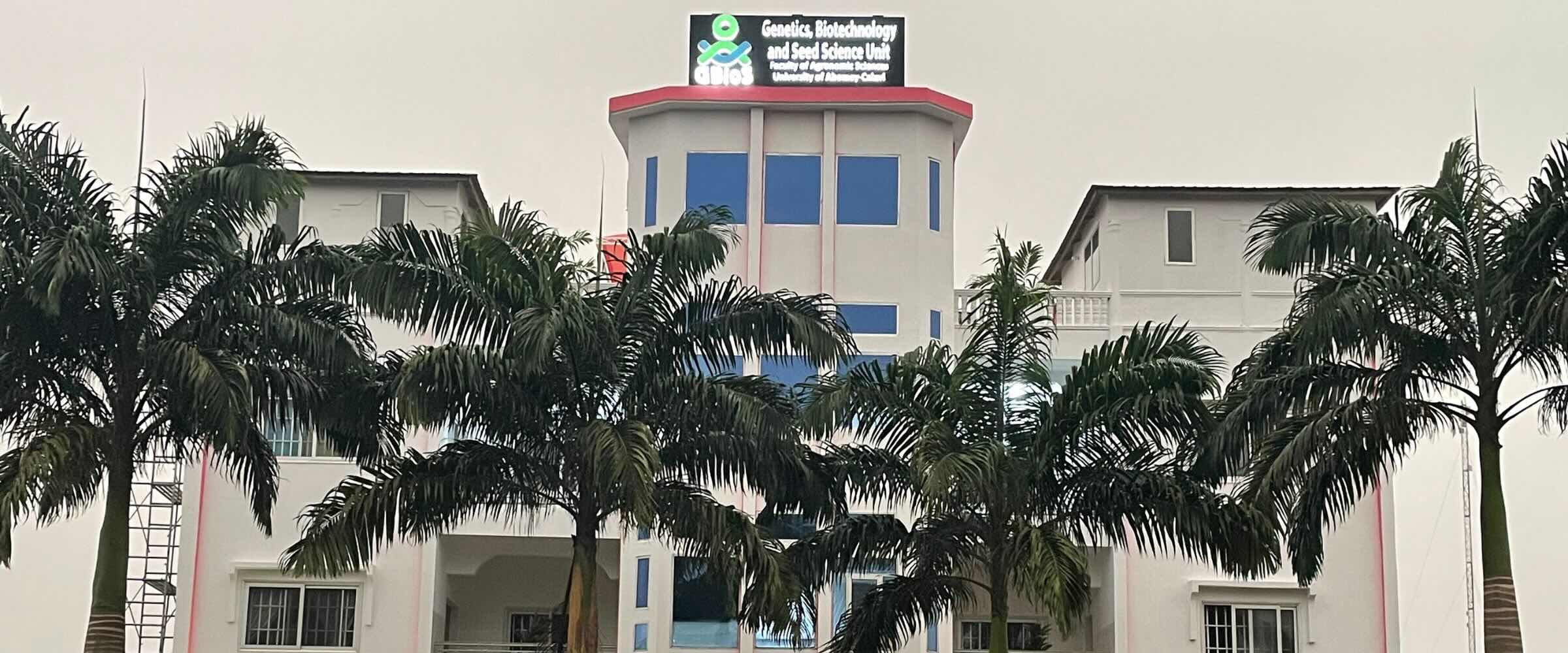 Front view of the GBioS building at the University of Abomey-Calavi, lined with palm trees